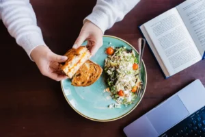 Hudsons Lunch Special. Lunch pictured is a grilled cheese with a summer fresh salad. Person is on a lunch break from work.